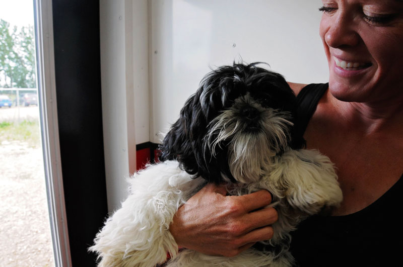 Small rescue dog with kennel staff. Small rescue dog with kennel staff.